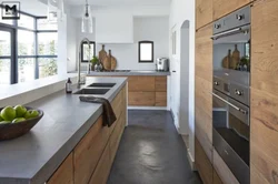 Concrete kitchen with wooden countertop in the interior