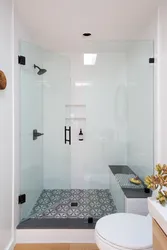 Photo of a bathroom with a shower behind glass