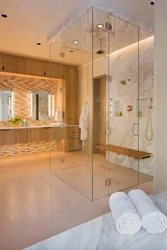Photo of a bathroom with a shower behind glass