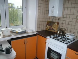 Kitchen design in an apartment with a gas stove and refrigerator photo