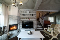 Photo of a living room in a country house with a fireplace