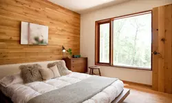 Wood and wallpaper in one bedroom interior
