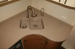 Kitchen with a round sink made of artificial stone photo