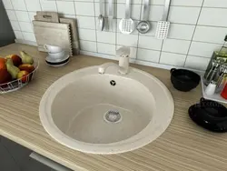 Kitchen with a round sink made of artificial stone photo
