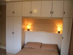 Wardrobe with sofa in bedroom photo