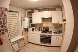 Kitchen interior with gas heater in Khrushchev and refrigerator