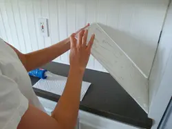 How to glue a panel to a wall in the kitchen photo