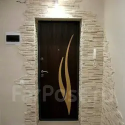 Photo of the entrance door to the apartment in stone