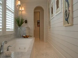 Finishing a bathroom in a wooden house with plastic panels photo