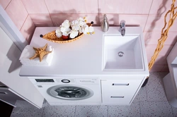 Photo of a bathroom cabinet with a washing machine