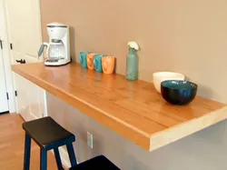 Table attached to the wall in the kitchen photo