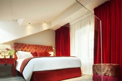Red curtains in the bedroom interior