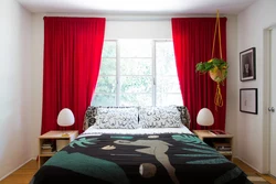 Red curtains in the bedroom interior