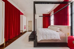 Red curtains in the bedroom interior