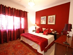 Red curtains in the bedroom interior