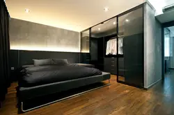Glass wardrobe in the bedroom interior