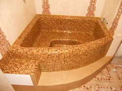 Do-it-yourself bathtub made of bricks and tiles photo