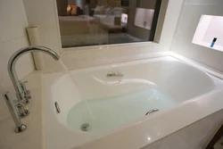 Photo of a bathtub with water in an apartment