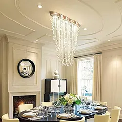 Chandelier in the living room above the table in the interior