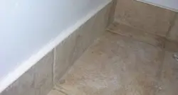 Baseboard for bathroom floor on tiles photo