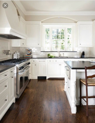 White kitchen design with brown countertops