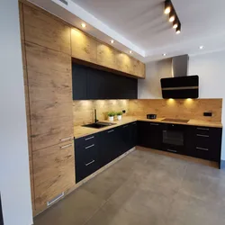 Dark kitchen with wooden countertop in the interior