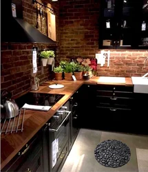 Dark kitchen with wooden countertop in the interior