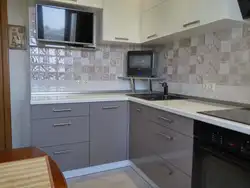 Photo of a small kitchen with a TV