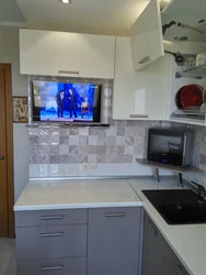 Photo of a small kitchen with a TV