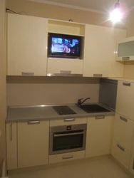 Photo Of A Small Kitchen With A TV