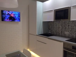 Photo Of A Small Kitchen With A TV