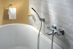 Photo of the bathtub where the faucets are on the bathtub