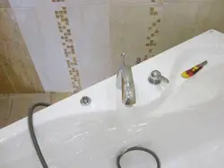 Photo of the bathtub where the faucets are on the bathtub
