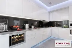 White kitchen in the interior with a dark apron