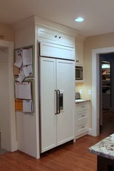 Refrigerator in a niche in the interior of the kitchen