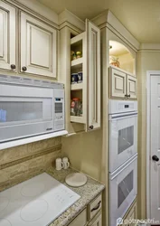 Refrigerator in a niche in the interior of the kitchen