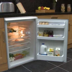 Narrow refrigerator in a small kitchen photo
