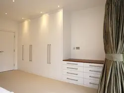 White wardrobe in the bedroom in the interior photo
