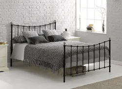 White metal bed in the bedroom interior