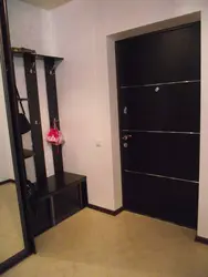 Photo Of The Hallway In An Apartment With Dark Doors