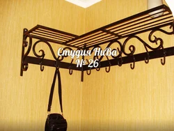Metal wall hangers for clothes in the hallway photo