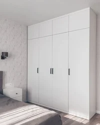 Bedroom wardrobe with hinged doors, light photo