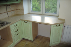 Corner kitchen design with countertop by the window