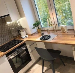 Corner kitchen design with countertop by the window