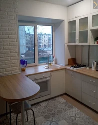 Corner kitchen design with countertop by the window