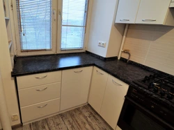 Corner kitchen design with countertop by the window