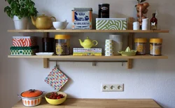 Shelves above the table in the kitchen interior photo