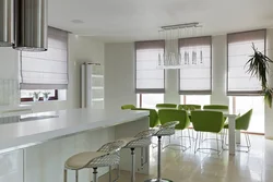 Green chairs in the interior of a white kitchen