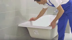 Installation of a bathtub in the bathroom photo