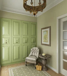 Green wardrobe in the hallway interior